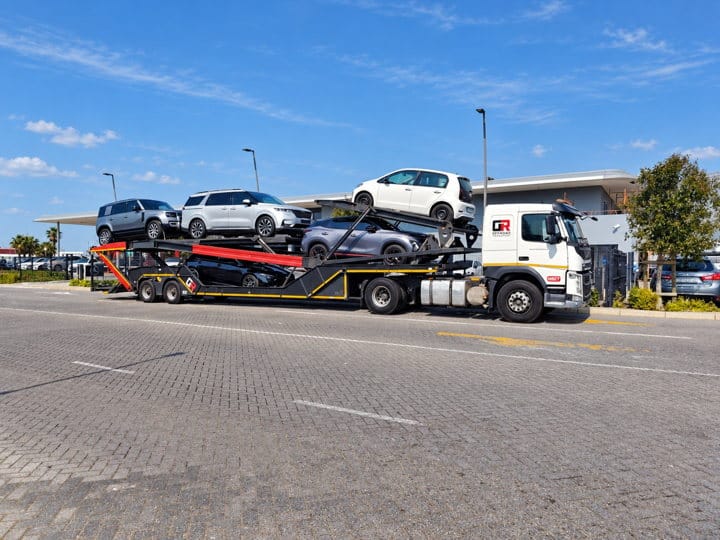 Open Road Carriers — cars loaded on a transporter.