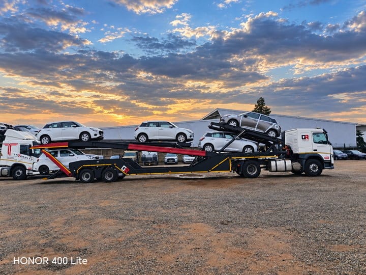 Open Road Carriers — a vehicle carrier at sunset.