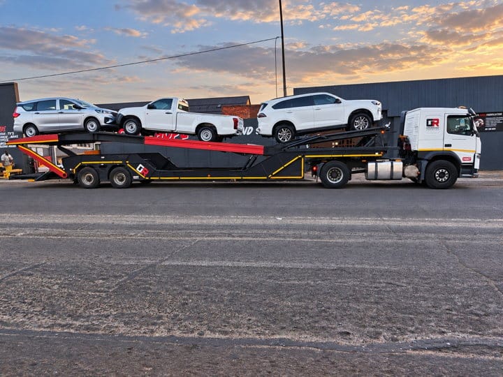 Open Road Carriers — a vehicle carrier at sunset.