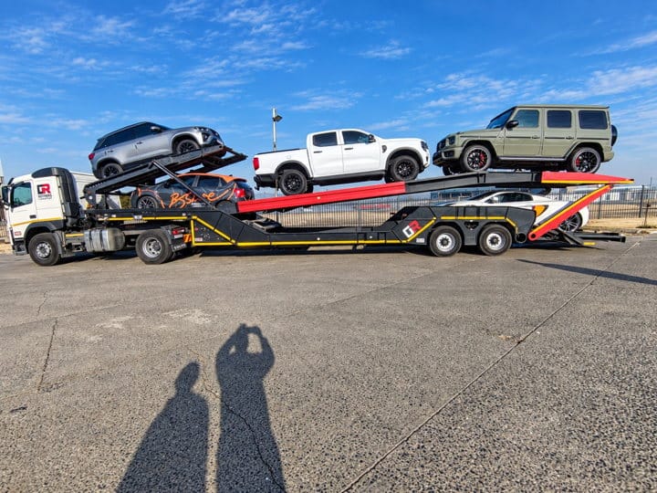 Open Road Carriers — cars loaded on a transporter.